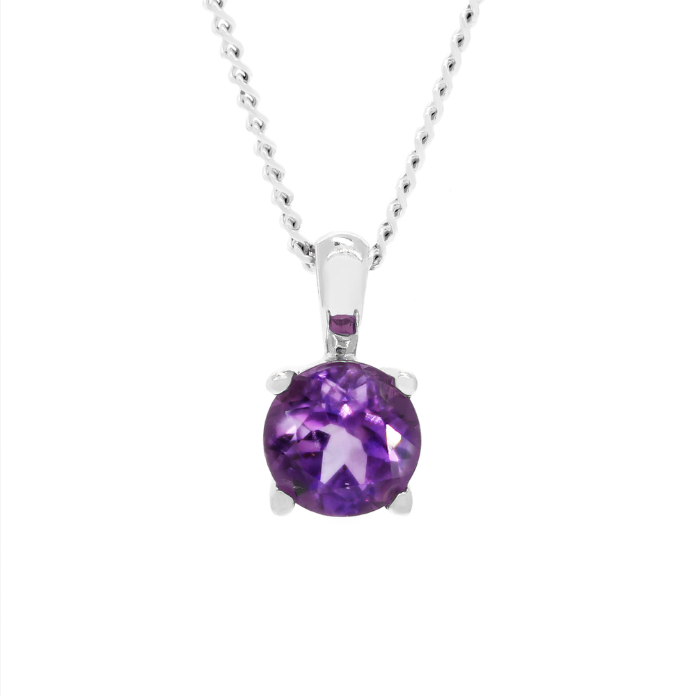 A product photo of a silver pendant with a deep purple amethyst centre stone. The stone is held in place by four delicate silver claws, and reflects stunning violet light from its many edges. The pendant is suspended by a silver chain against a white background.