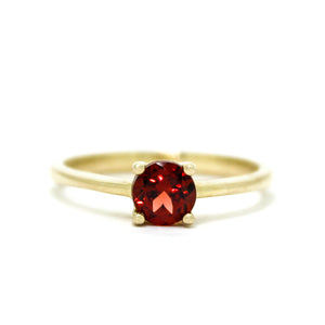 
            
                Load image into Gallery viewer, A product photo of a Round Garnet Solitaire Ring in 9k Yellow Gold sitting on a plain white background. The garnet centrestone measures 5.5mm. The stones are a deep red, reflecting sanguine hues across their multi-faceted edges.
            
        