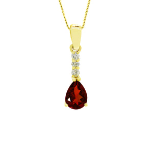 A product photo of a 7x5mm Pear Garnet & Diamond Earrings in 9k Yellow Gold suspended against a white background. A golden strip connects the garnet to the stud, adorned with 3 diamonds. It is suspended by a simple gold chain. The garnet reflects sanguine hues across its multi-faceted edges.