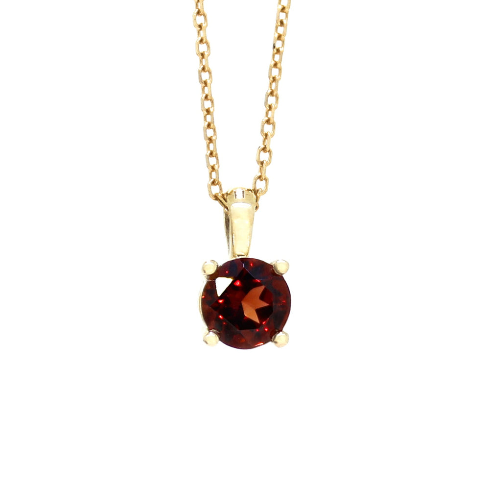 A product photo of a 6mm Round Garnet Pendant in 9k Yellow Gold in 9k Yellow Gold suspended against a white background. The stone is held in place by 4 delicate golden claws. It is suspended by a simple gold chain. The garnet reflects sanguine hues across its multi-faceted edges.