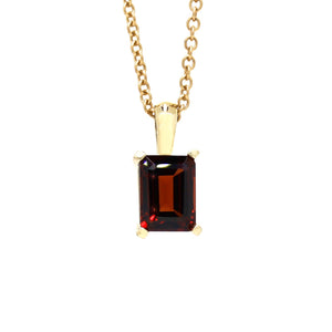 A product photo of a 8x6mm Rectangular Garnet Pendant in 9k Yellow Gold suspended against a white background. The impressively large and deeply-coloured stone is contrasted by its overall minimalistic design, 4 simple golden claws holding the gem in place. It is suspended by a simple gold chain. The stone is a deep red, reflecting sanguine hues across its multi-faceted edges.