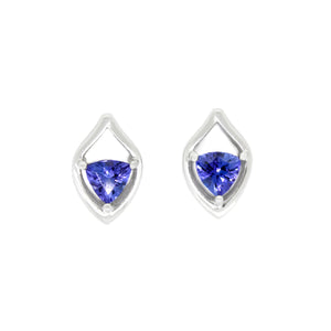 
            
                Load image into Gallery viewer, A product photo of white gold tanzanite studearrings sitting on a white background. The trilliant stones are held in place by 3 claws each within thick, white gold frames in the shapes of teardrops. The deep blue tanzanites reflect violet blue and indigo light from their many edges.
            
        