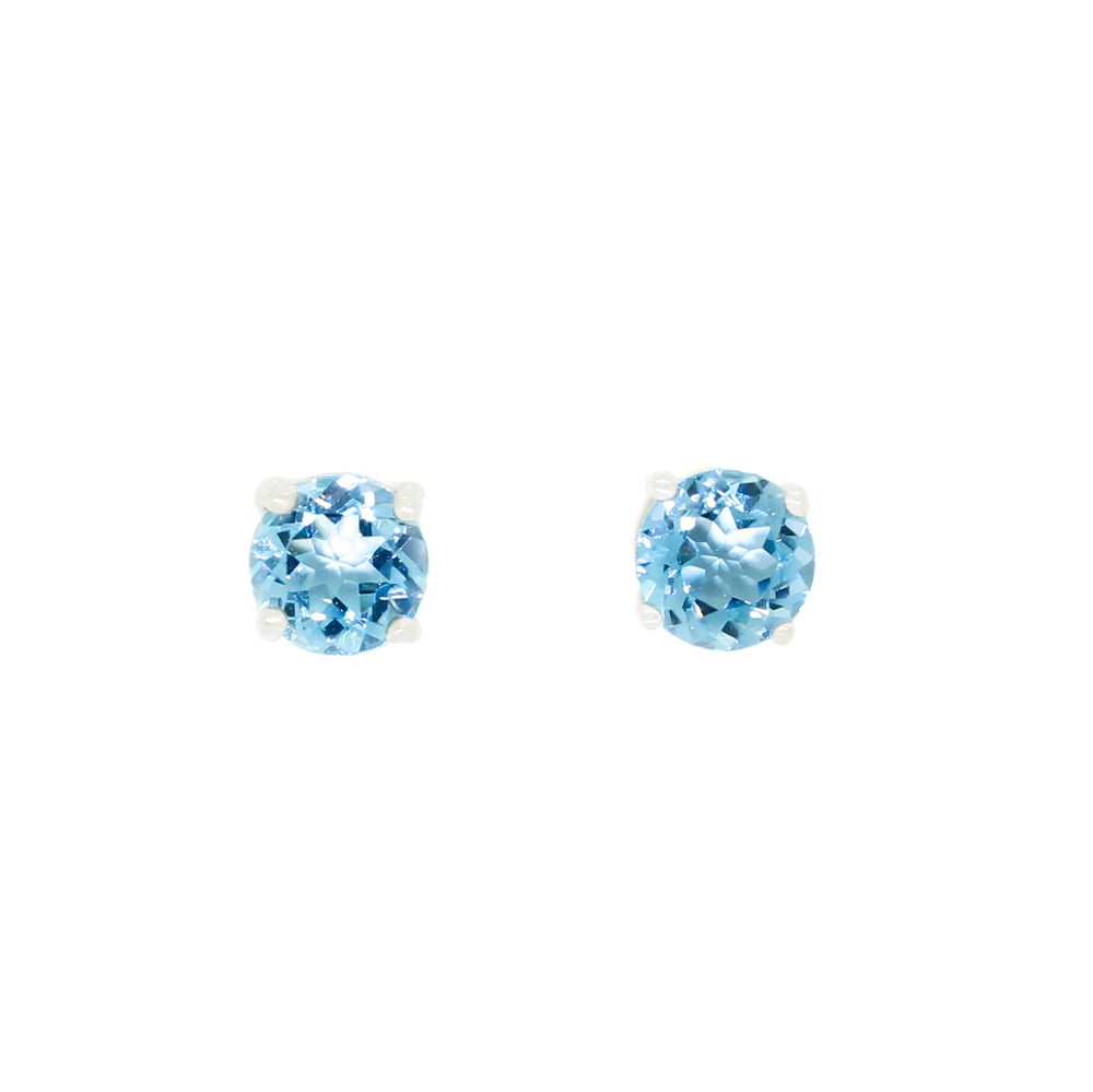 A product photo of two silver stud earrings sitting on a white background. Held in place by 4 silver claws each are two dazzling round-cut blue topaz stones, reflecting cerulean light from their many edges.