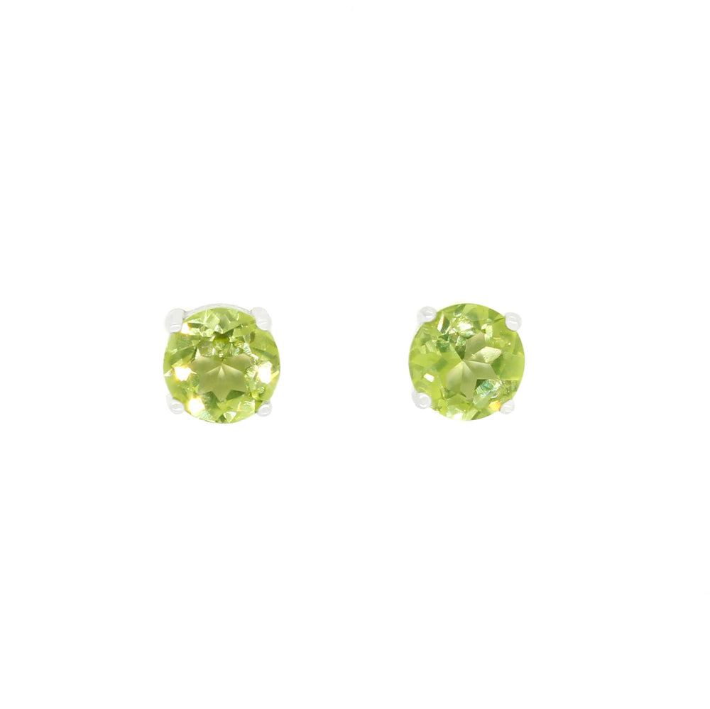 A product photo of two silver stud earrings sitting on a white background. Held in place by 4 silver claws each are two dazzling round-cut peridots, reflecting green and yellow-toned shades from their many edges.