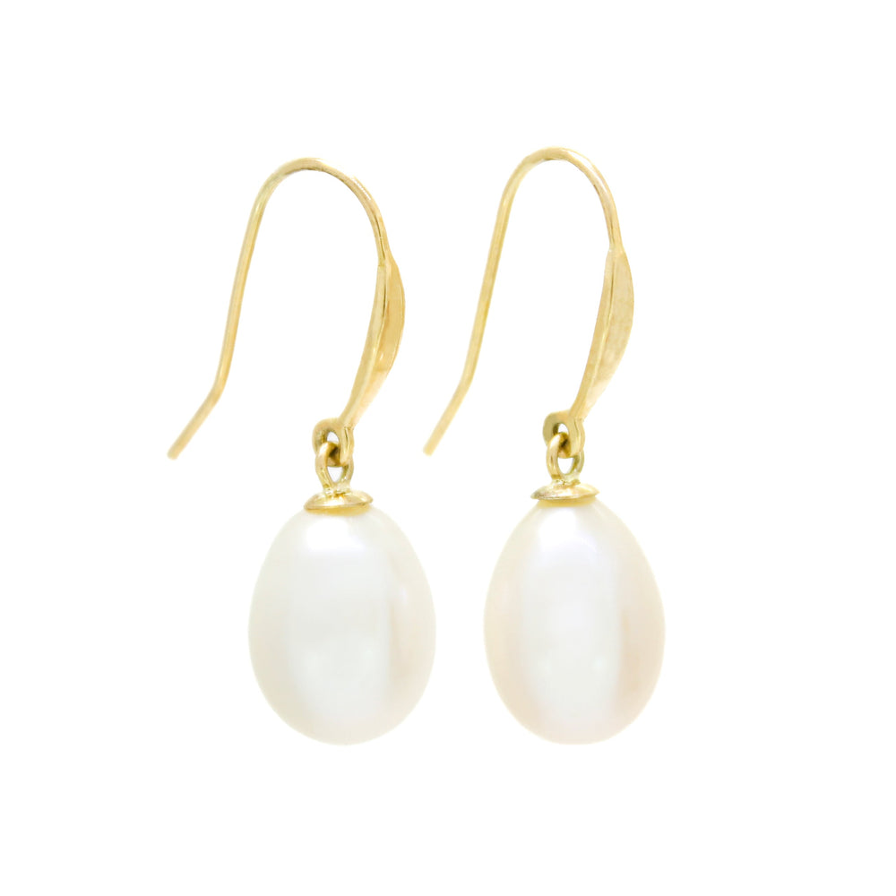 A product photo of a simple pair of yellow gold shepherd's hook earrings suspending two creamy white pearls over a white background.
