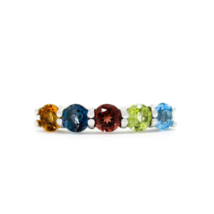 
            
                Load image into Gallery viewer, A product photo of a bold, multi-gemstone ring in 9k yellow gold – made up of rainbow-coloured jewels – sitting on a white background. From left to right, 4.5mm round-cut
            
        