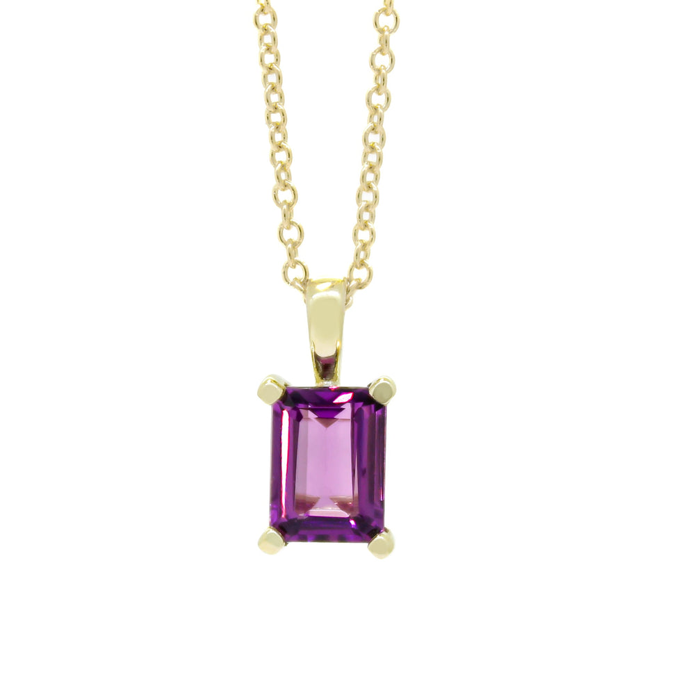 A product photo of a 8x6mm Rectangular Rhodalite Pendant in 9k Yellow Gold suspended against a white background. The impressively large and deeply-coloured stone is contrasted by its overall minimalistic design, 4 simple golden claws holding the gem in place. It is suspended by a simple gold chain. The rhodalite reflects warm, pinky purple hues across its multi-faceted edges.