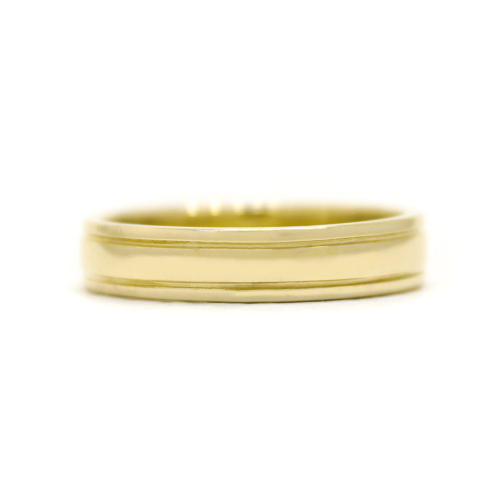 A product photo of a mens' ring made of 9k yellow gold. The band is 5mm tall and detailed with two polished grooves running along its length.