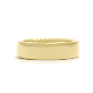 A product photo of a mens' ring made of 9k yellow gold. The flat band is 5mm tall and 1.5mm wide, making its squared edges thick and weighted.