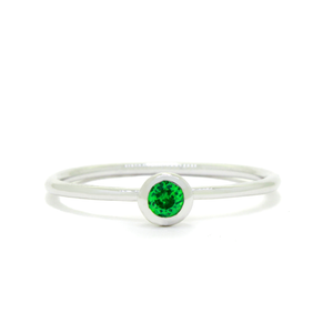 
            
                Load image into Gallery viewer, A product photo of a delicate white gold stacking ring with a tiny, bezel-set mint green tourmaline in the centre sitting on a white background. The band is slim and thread-like, with the focus drawn to the petite 3mm glinting green centre stone. The green gemstone colour be a good emerald substitute.
            
        