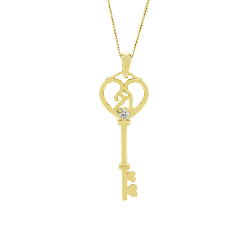 A product photo of a ceremonial diamond key pendant for one's 21st birthday, set in solid 9ct yellow gold. The bow of the key is shaped like a heart, with another loop connecting the design to the bail. Within the heart are the numbers 21 formed in gold, placed above a single white diamond embedded in the centre of the key. The shank is smooth gold, with the key's two wards also shaped as little hearts.
