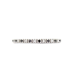 A product photo of a delicate, dazzling diamond eternity ring set in 9ct white gold. The ring is made up of alternating black and white diamond jewels that detail the entire circumference of the band.