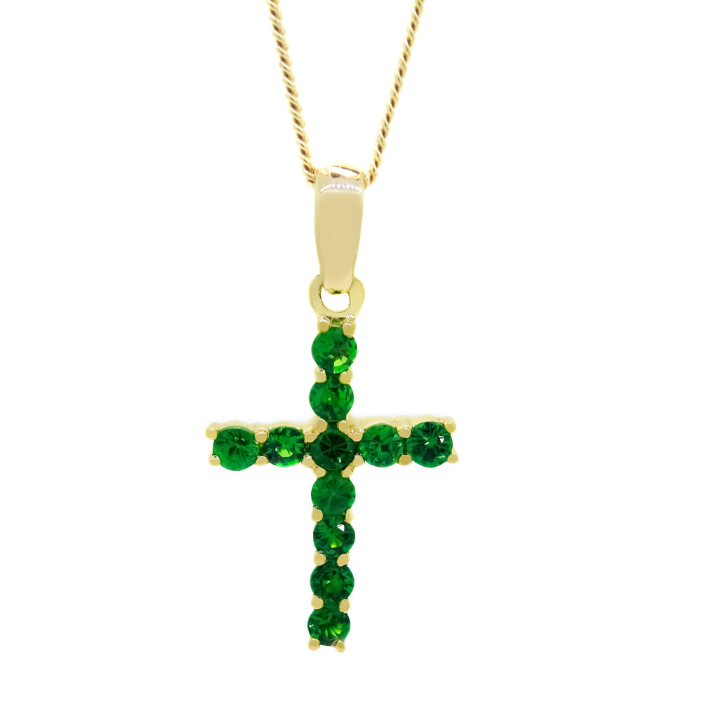 
            
                Load image into Gallery viewer, A product photo of a dainty cross pendant delicately bejewelled with electric green tsavorite stones suspended against a white background. The Christian cross pendant is made up of 11 stones in total, which reflect verdant hues from their facets.
            
        