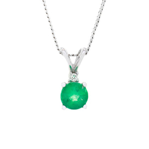 
            
                Load image into Gallery viewer, A product photo of a delicate, ornate emerald pendant with a single diamond accent suspended against a white background.
            
        