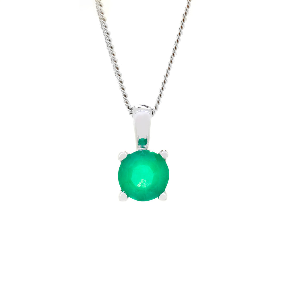 A product photo of a white gold emerald pendant suspended by a chain against a white background. The round stone is held in place by 4 small claws, and reflects ocean green hues from its many edges.
