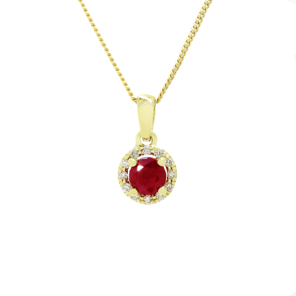 A product photo of a 0.82ct Round Ruby Pendant with a Diamond Halo in 9k Yellow Gold suspended against a white background. The circle-cut ruby stone is surrounded by a thick frame of ornately detailed yellow gold and diamond detailing. It is suspended by a simple gold chain. The stone is a deep pinky red, reflecting sanguine and magenta hues across its multi-faceted edges.