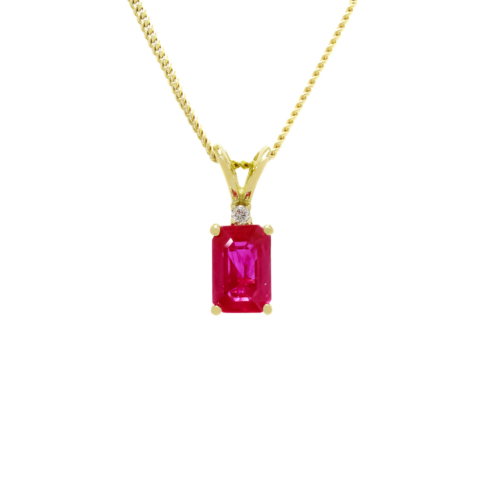 A product photo of a 0.66ct rectangular ruby and diamond pendant in 9k yellow gold suspended against a white background. The rectangular, emerald-cut ruby is a stunningly bright magenta colour, with deep natural inclusions making the stone appear as though deep red ink is swirling within. A single white diamond sits atop it, before meeting the split golden bail.