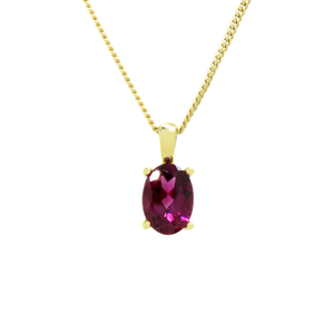 
            
                Load image into Gallery viewer, A product photo of a yellow gold rhodalite pendant suspended by a chain against a white background. The oval stone is held in place by 4 small claws, and reflects deep purple and magenta colours from its many edges.
            
        
