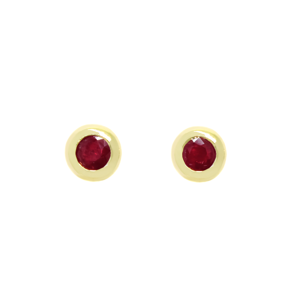 A product photo of 4mm Round Bezel-Set Ruby Earring Studs in 9k Yellow Gold sitting on a plain white background. The 2 ruby stones measure 4mm across and are deep red, reflecting sanguine and burgundy hues across their multi-faceted edges, framed in a thick layer of yellow gold.