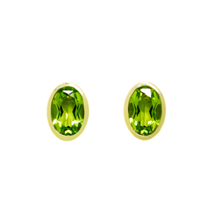 
            
                Load image into Gallery viewer, A product photo of a pair of peridot earrings in 9ct yellow gold sitting on a white background. The fine 6x4mm peridots are framed in a thick layer of yellow gold in a bezel setting.
            
        