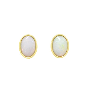 A product photo of an elegant pair of 7x5mm fiery white opal earrings bezel-set in solid 9ct yellow gold.