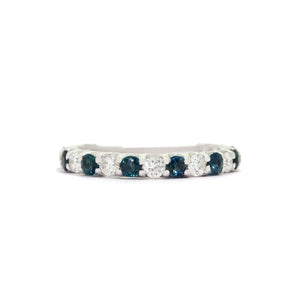 A product photo of a bold, alternating-gemstone eternity ring in 9k white gold – made up of 19 2.4mm round sapphire and white diamond stones – sitting on a white background.