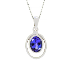 
            
                Load image into Gallery viewer, A product photo of a Bezel-set Tanzanite Pendant in 9ct White Gold sitting on a plain white background. The bezel-set stone is nestled at the top of a golden oval loop of similar thickness to the bezel frame. The tanzanites reflect violet and indigo hues across their multi-faceted edges.
            
        