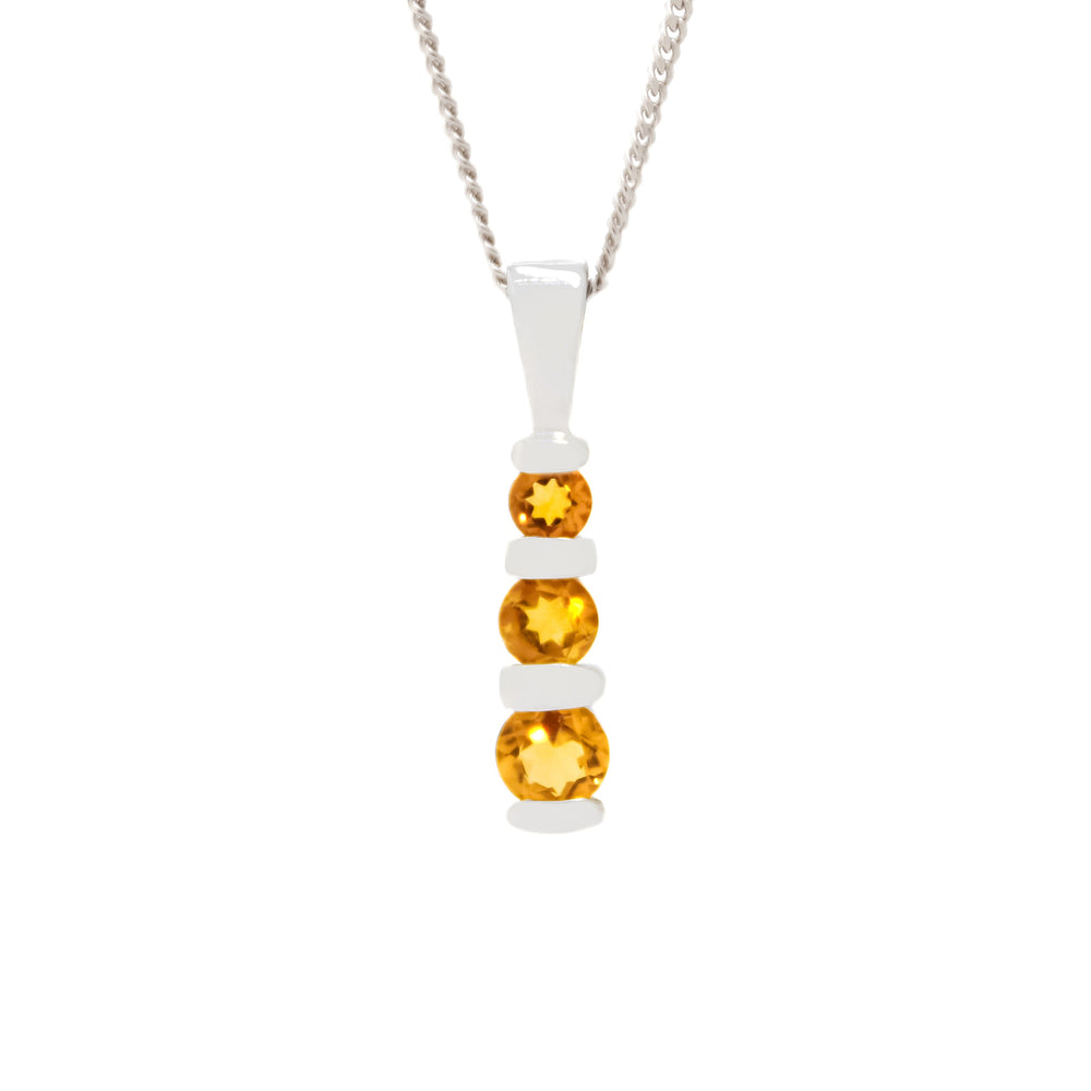 A product photo of a 9ct white gold citrine pendant made up of 3 stones stacked vertically, descending from smallest to largest. The pendant is suspended by a golden chain against a white background.