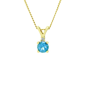 A product photo of a 0.45ct round blue topaz and diamond necklace in 9k yellow gold suspended against a white background. The delicate topaz gemstone is a stunningly bright sky blue colour. A single white diamond sits atop it, before meeting the split golden bail.