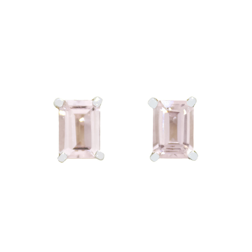 
            
                Load image into Gallery viewer, A product photo of a pair of 9ct white gold morganite earrings sitting on a white background. The emerald-cut 7x5mm morganite stones are held in place by 4 golden claws, and reflect baby pink hues from their edges.
            
        