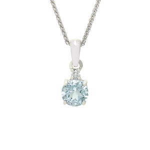 A product photo of a large, 6mm round aquamarine and diamond pendant suspended by a 9ct white gold chain over a plain white background. The 0.70ct aquamarine stone is a pale baby blue colour.