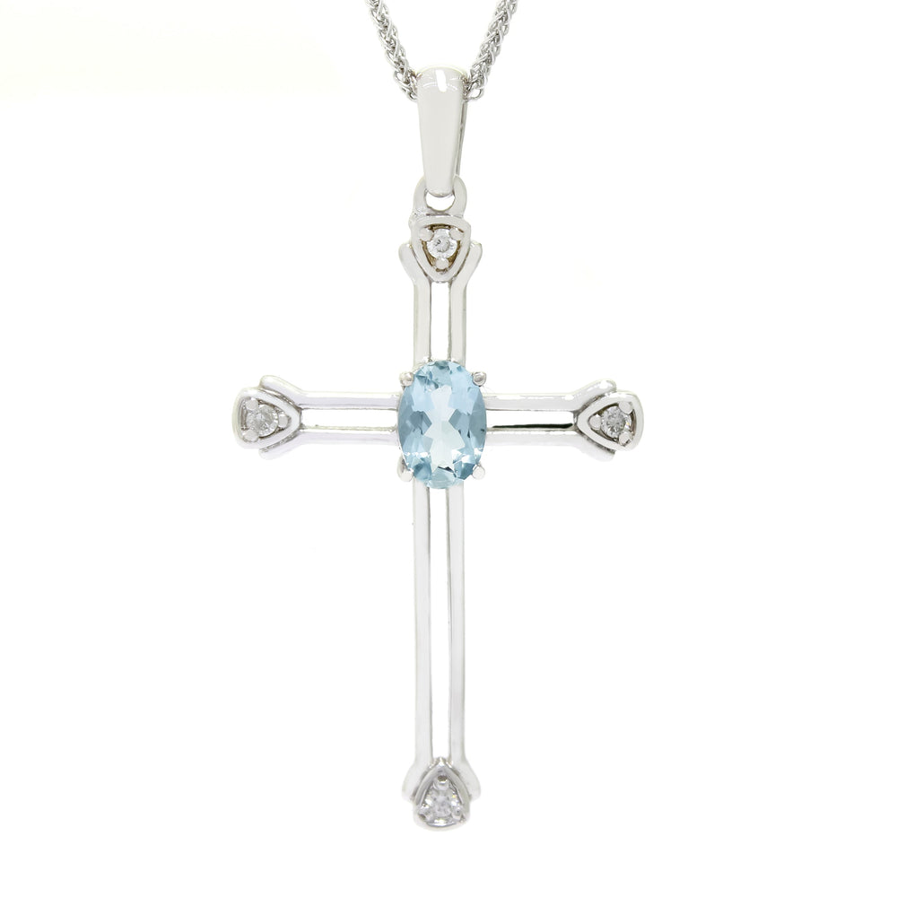 A product photo of a white gold aquamarine and diamond pendant in the shape of a Christian cross. At the ends of each limb, a tiny white diamond marks the tip, to a total of 4 diamonds. At the heart of the cross is a dainty baby blue aquamarine centre stone.