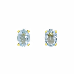 
            
                Load image into Gallery viewer, A product photo of 7x5mm Oval Shaped Aquamarine Earring Studs in 9k Yellow Gold sitting on a plain white background. The 2 aquamarine stones measure 5mm across and are a light blue colour, reflecting baby blue hues across their multi-faceted edges, and are each held in place by dainty golden claws.
            
        