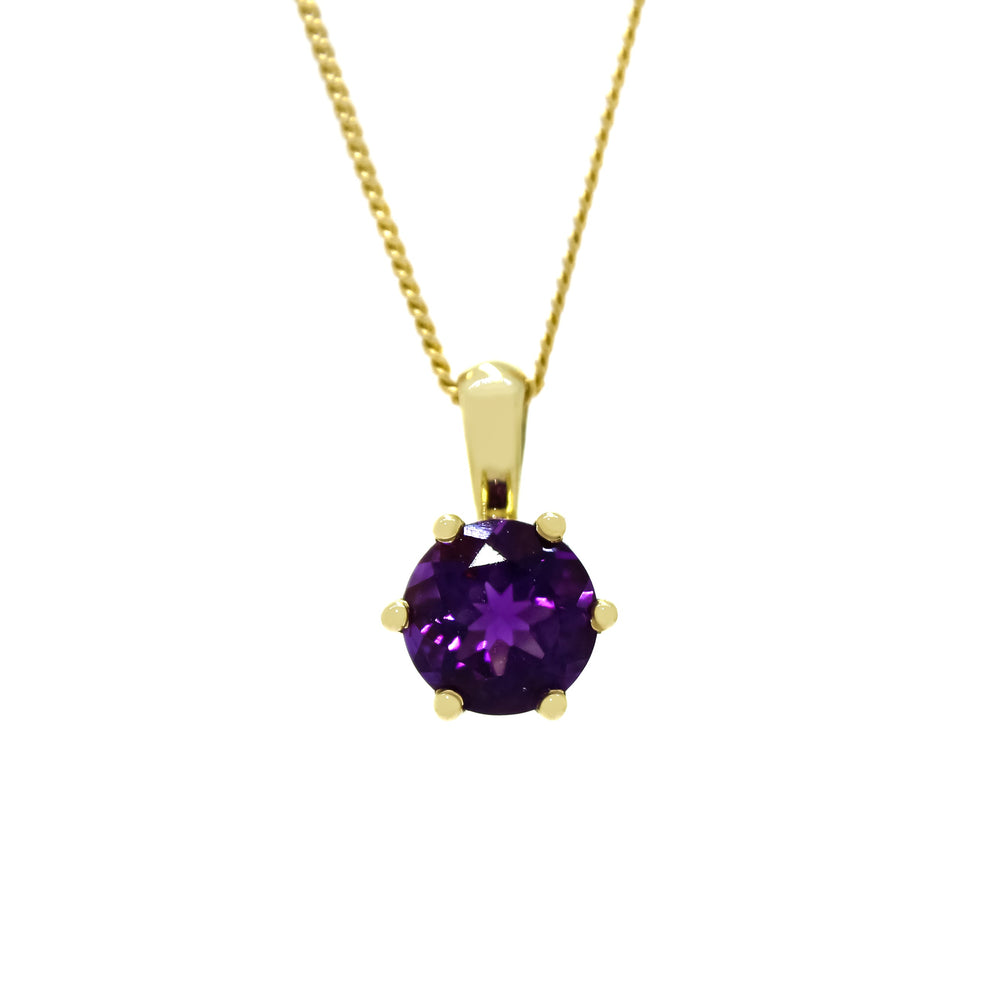 A product photo of a white gold amethyst pendant against a white background. The highly-reflective circle cut amethyst stone is held in place by 6 dainty white gold claws. It is suspended by a simple white gold chain.
