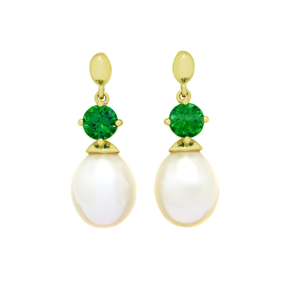This product image features a pair of solid yellow gold gemstone and pearl earrings with a unique design. The main components are two electric green round-cut tsavorite jewels, each one set above a single, white drop pearl.