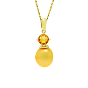 This product image is a close-up of a beautiful solid 9 karat yellow gold pearl and gemstone pendant design suspended by a gold chain. The pendant primarily features a round-cut citrine stone in the centre, set with delicate gold claws above a single golden orange drop-shaped pearl, beautifully matching in colour. A thin gold chain connects to the pendant.
