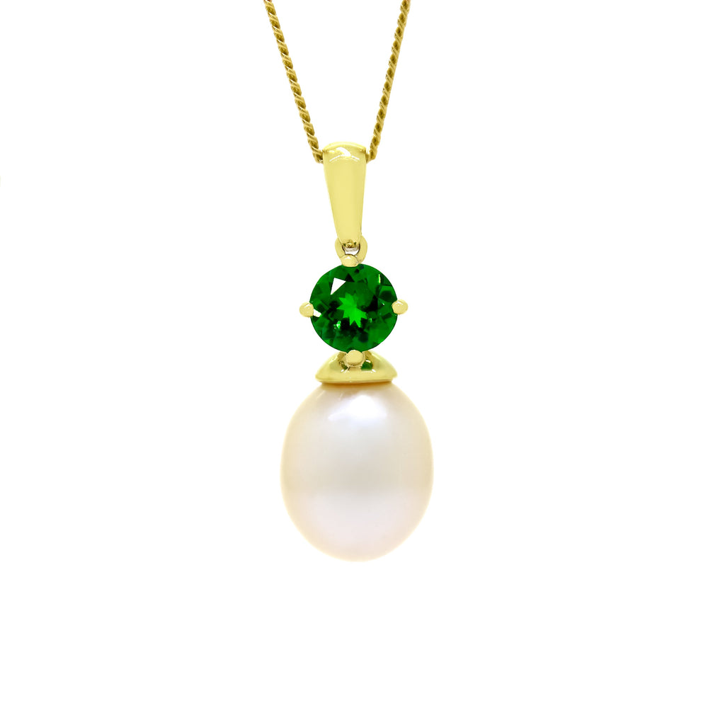 This product image is a close-up of a beautiful solid 9 karat yellow gold pearl and gemstone pendant design suspended by a gold chain. The pendant primarily features a round-cut electric green tsavorite stone in the centre, set with delicate gold claws above a single white drop-shaped pearl. A thin gold chain connects to the pendant.