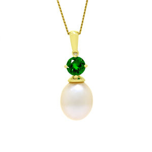 This product image is a close-up of a beautiful solid 9 karat yellow gold pearl and gemstone pendant design suspended by a gold chain. The pendant primarily features a round-cut electric green tsavorite stone in the centre, set with delicate gold claws above a single white drop-shaped pearl. A thin gold chain connects to the pendant.