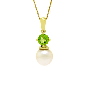 This product image is a close-up of a beautiful solid 9 karat yellow gold pearl and gemstone pendant design suspended by a gold chain. The pendant primarily features a round-cut bright green peridot stone in the centre, set with delicate gold claws above a single white round-shaped pearl. A thin gold chain connects to the pendant.