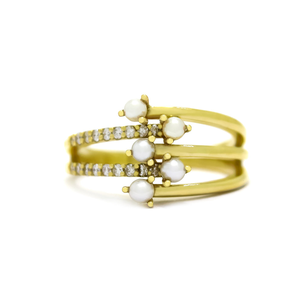 This product image shows a pearl and diamond 9 karat yellow gold ring with an intricate five-pronged design, holding 5 2mm white seed pearls in a staggered formation in the centre. Three prongs extend from the one side of the ring, with a tiny little pearl on the end of each one. Two diamond-embedded prongs extend from the other.