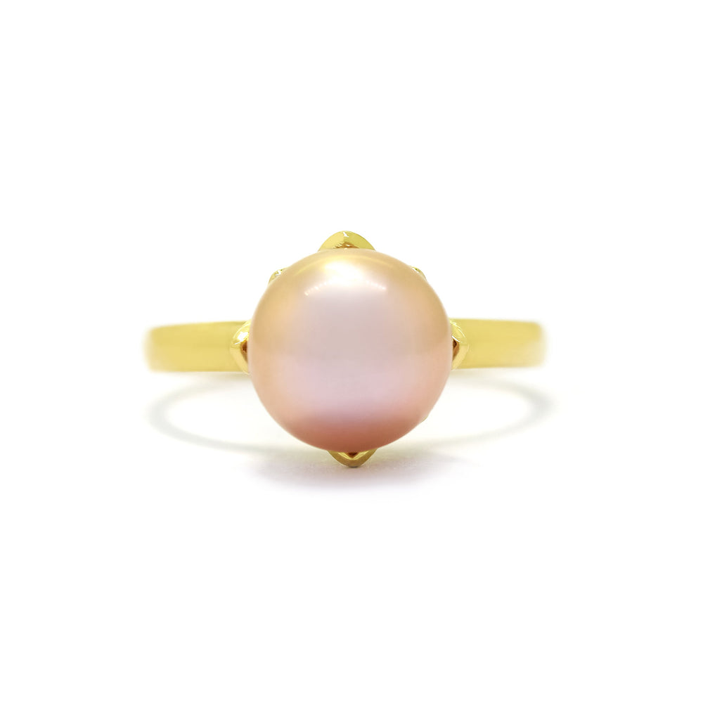 This product image shows a 10mm rounded rosaline pearl solitaire ring set in solid 9 karat yellow gold. The pearl is held in place by a floral-type setting extending outwards from the band like petals are pearl.
