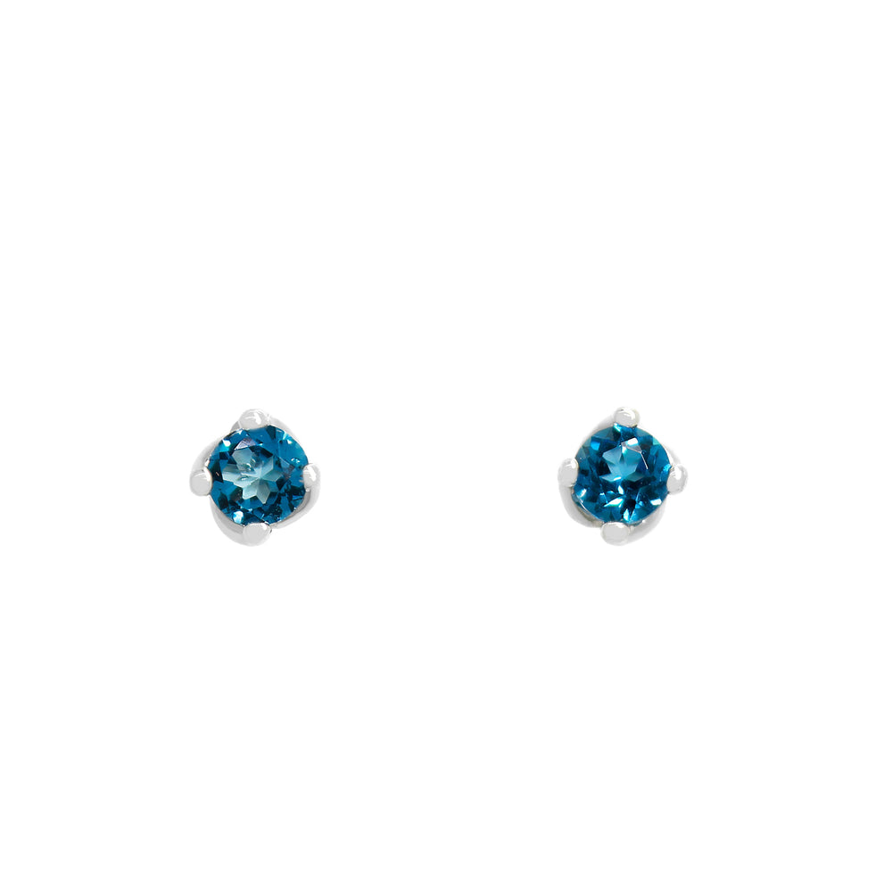 A product photo of 3mm Round London Blue topaz silver stud earrings sitting on a plain white background. The stones are held in place by 4 delicate silver claws arranged in a flower-like pattern where they meet the stud.