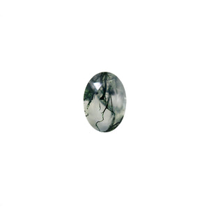 A product image of a loose 7x5mm faceted oval-cut moss agate stone. The stone has a cool white milky colour, with deep, swirling green natural inclusions - appearing as moss-like structures or delicate inkspills within the stone. The faceted edges reflect bright white light.