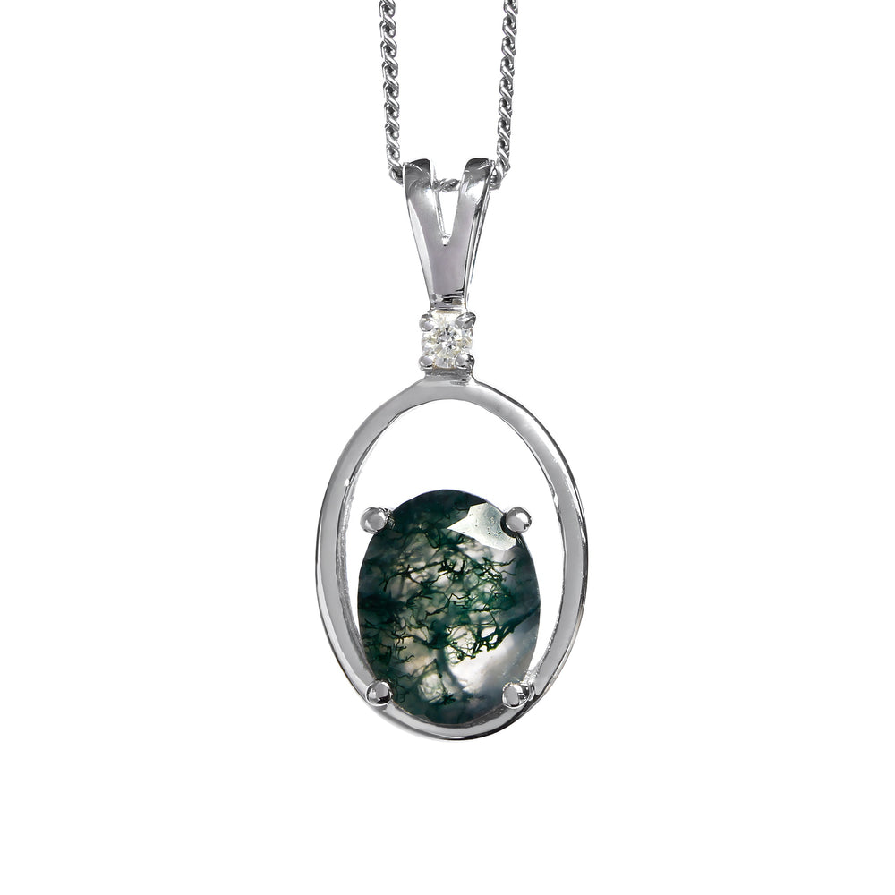 A product photo of a solid 9 karat white gold pendant with an oval-cut moss agate centre stone suspended by a chain against a white background. The oval stone is oriented vertically, and rests at the bottom of a golden frame in the shape of a larger oval, with a single white diamond attaching the frame to the bail.