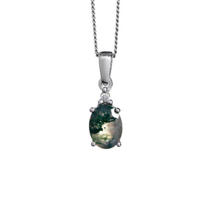 
            
                Load image into Gallery viewer, A product photo of a white gold moss agate and diamond necklace sitting against a white background. The beautifully unique moss agate stone is held in place by 4 pairs of claws at its top and bottom, with a trio of white diamonds connecting the stone to the rest of the pendant. It is suspended by a simple white gold chain.
            
        
