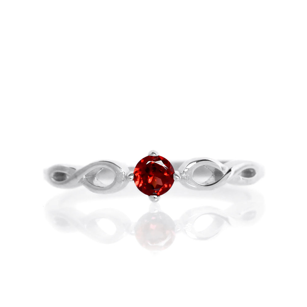 
            
                Load image into Gallery viewer, A product photo of an ornate silver ring with a garnet centre stone sitting on a white background. The silver band splits halfway along its length, becoming twisting and serpentine in appearance before meeting on either side of the dazzling red 3.5mm stone, which is held in place by 4 silver claws. The deep red gemstone colour would be a good ruby alternative.
            
        