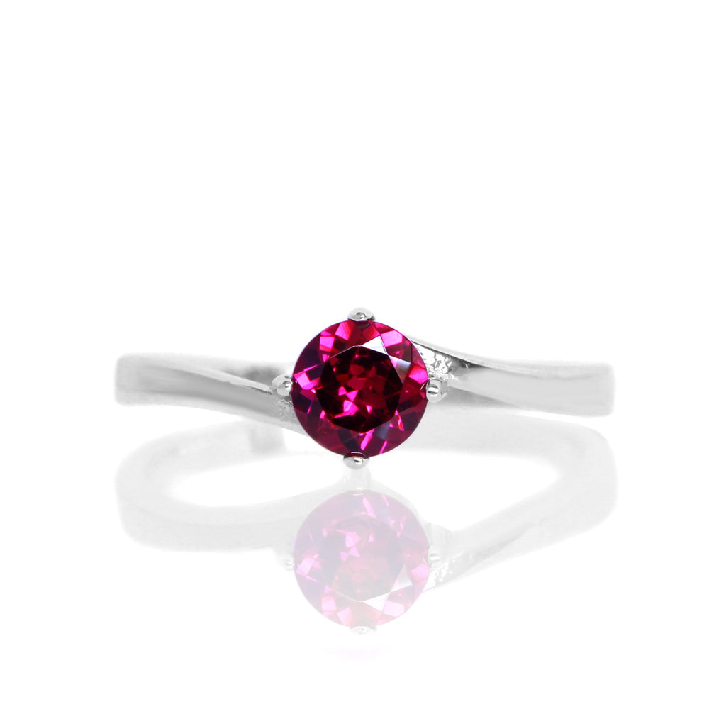 
            
                Load image into Gallery viewer, A product photo of a curved-band silver solitaire ring with a rhodalite centre stone sitting on a white background.
            
        