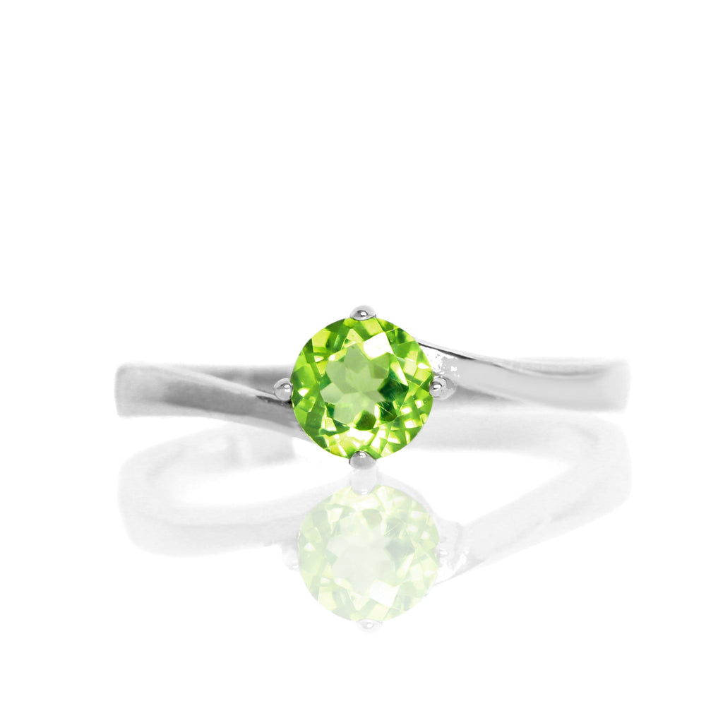 
            
                Load image into Gallery viewer, A product photo of a curved-band silver solitaire ring with a grass green peridot centre stone sitting on a white background.
            
        