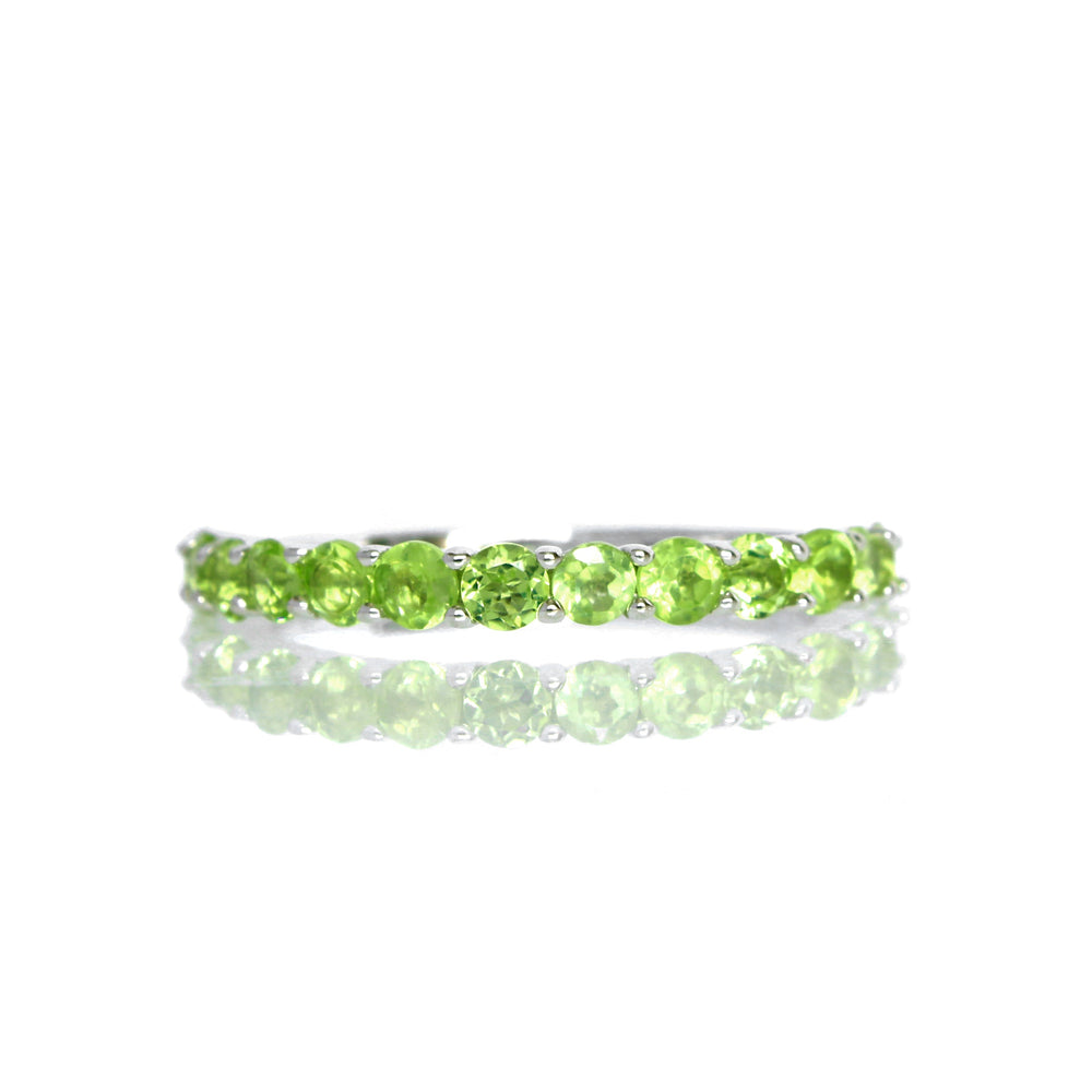 
            
                Load image into Gallery viewer, A product photo of a silver eternity band with 13 peridot stones embedded along its length on a white background.
            
        