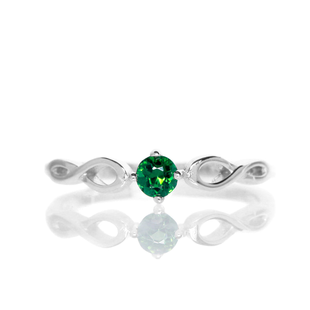 
            
                Load image into Gallery viewer, A product photo of an ornate silver ring with a green tourmaline centre stone sitting on a white background. The silver band splits halfway along its length, becoming twisting and serpentine in appearance before meeting on either side of the dazzling green 3.5mm stone, which is held in place by 4 silver claws.
            
        